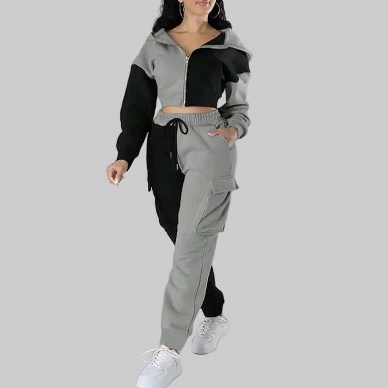 Person wearing a black and gray tracksuit on a white background