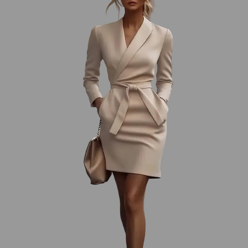 Woman in a beige dress walking on a city street
