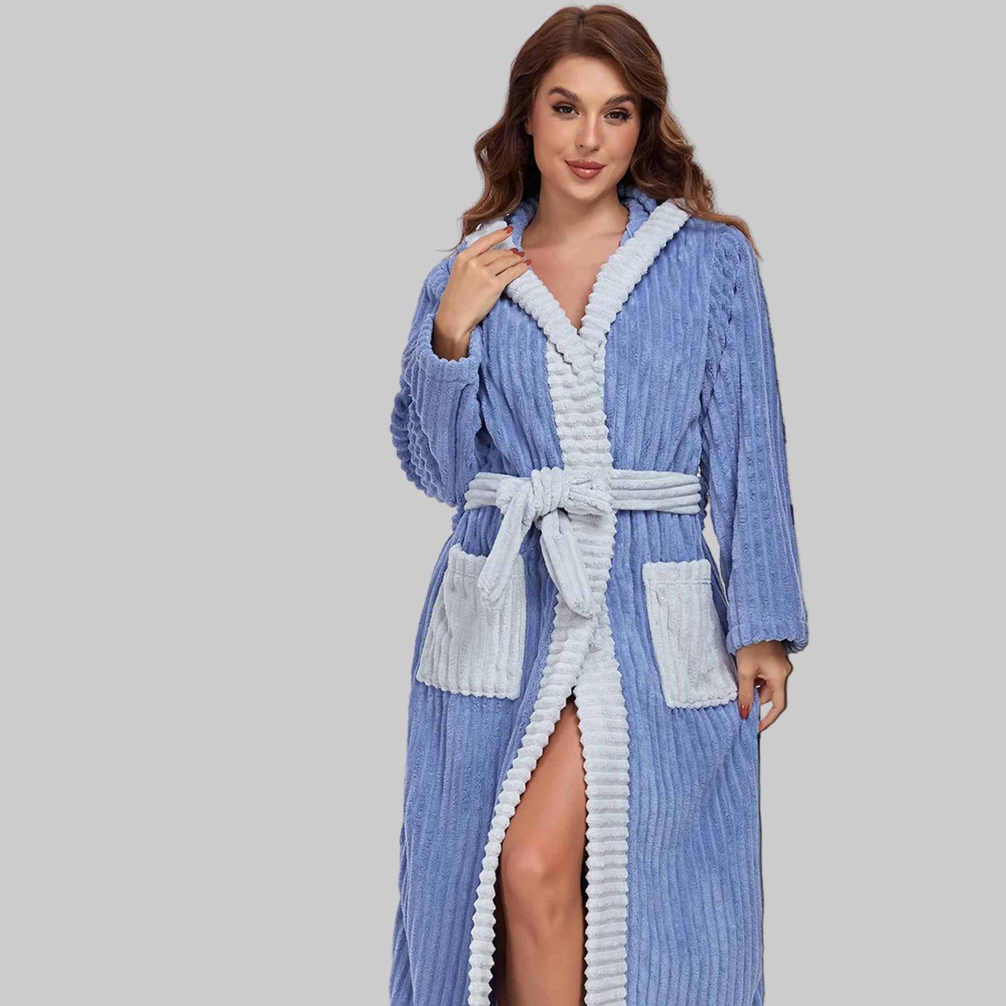 Woman wearing a blue and white robe in a bedroom setting